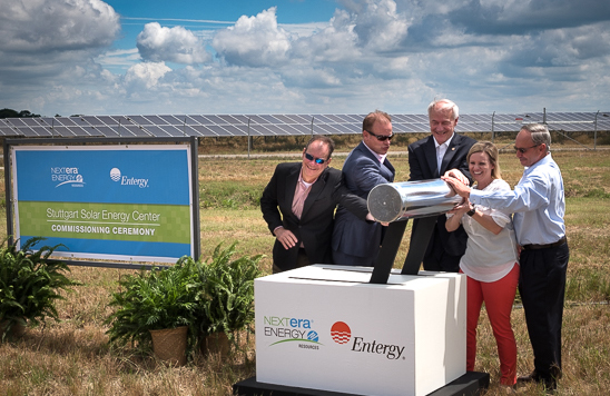 Flipping the symbolic switch are Armando Pimentel of NextEra, Riley, Gov. Asa Hutchinson, Bethany Heldebrand, CEO and executive director of the Stuttgart Chamber of Commerce, and Arkansas County Judge Thomas Best. 